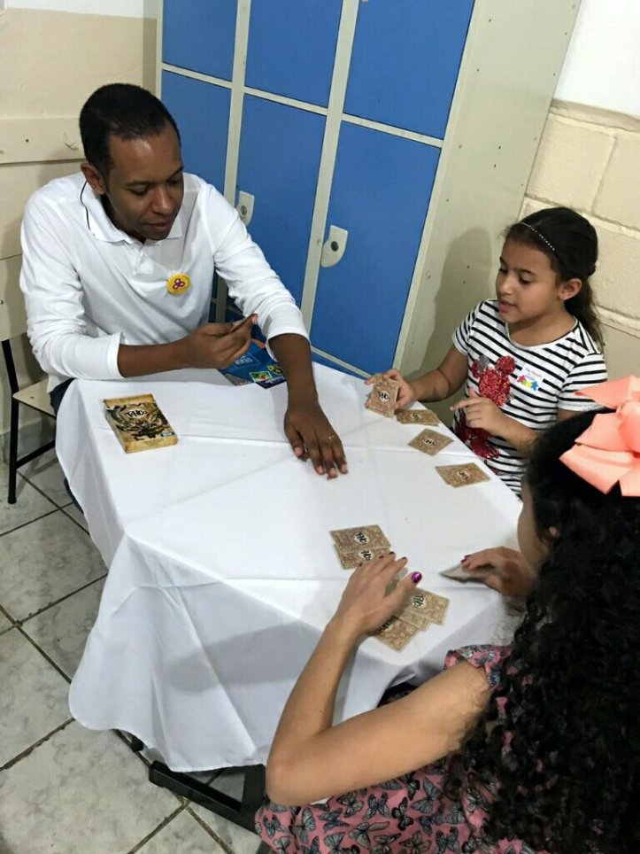 Família jogando Tinco da DEVIR na festa da família na escola Cristã Jardim das Oliveiras